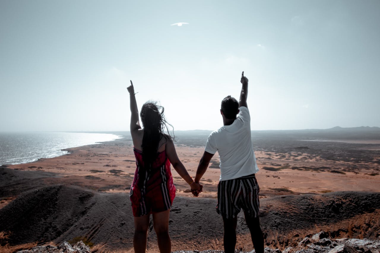 Couple pointing to the sky.