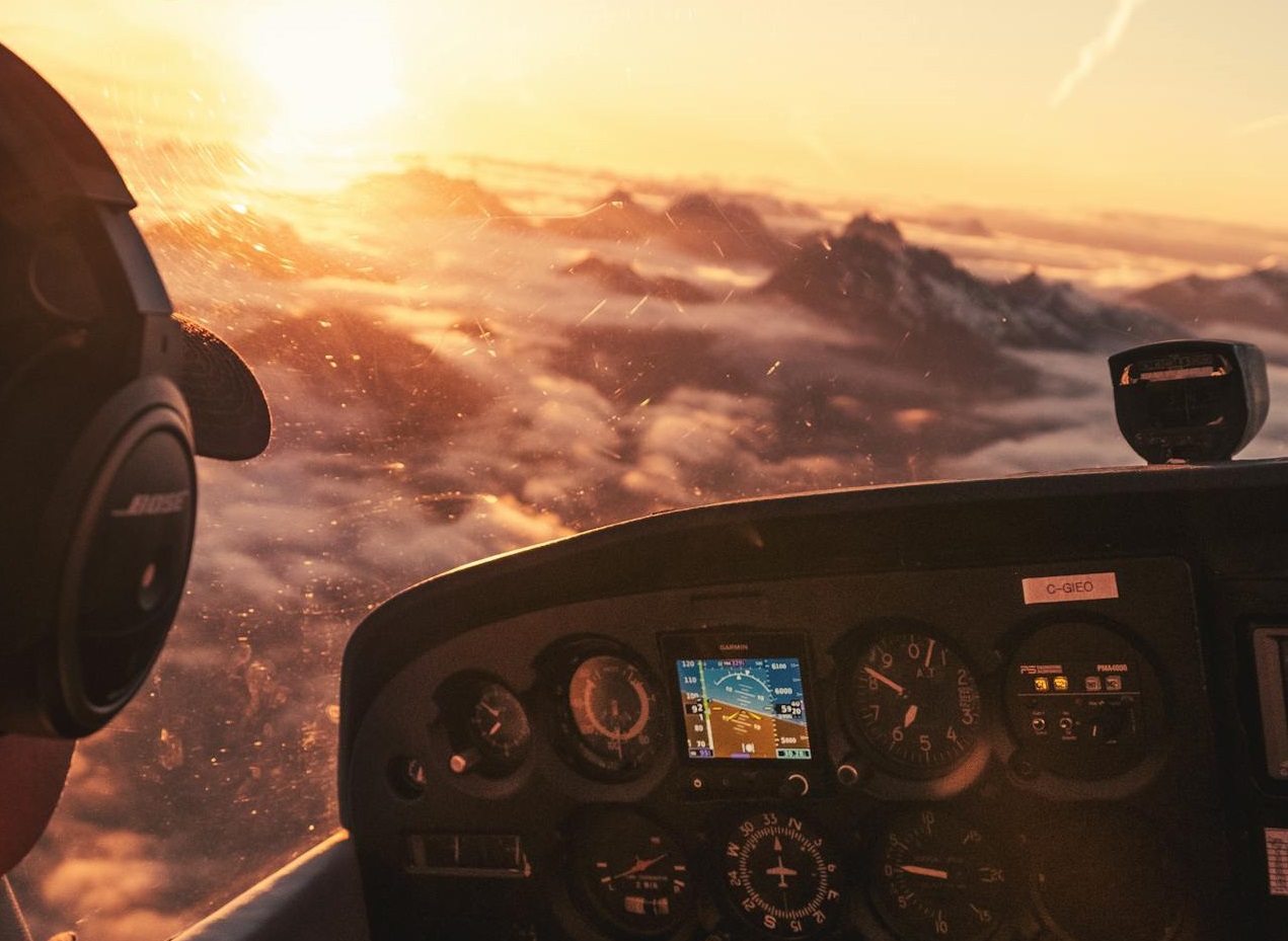 Pilot looking at airplane window.