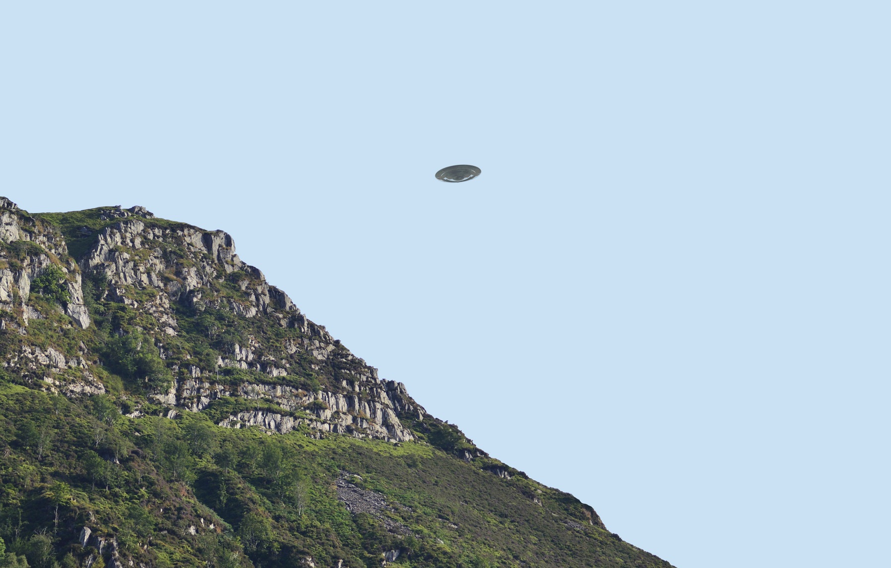 Flying saucer UFO over bluff