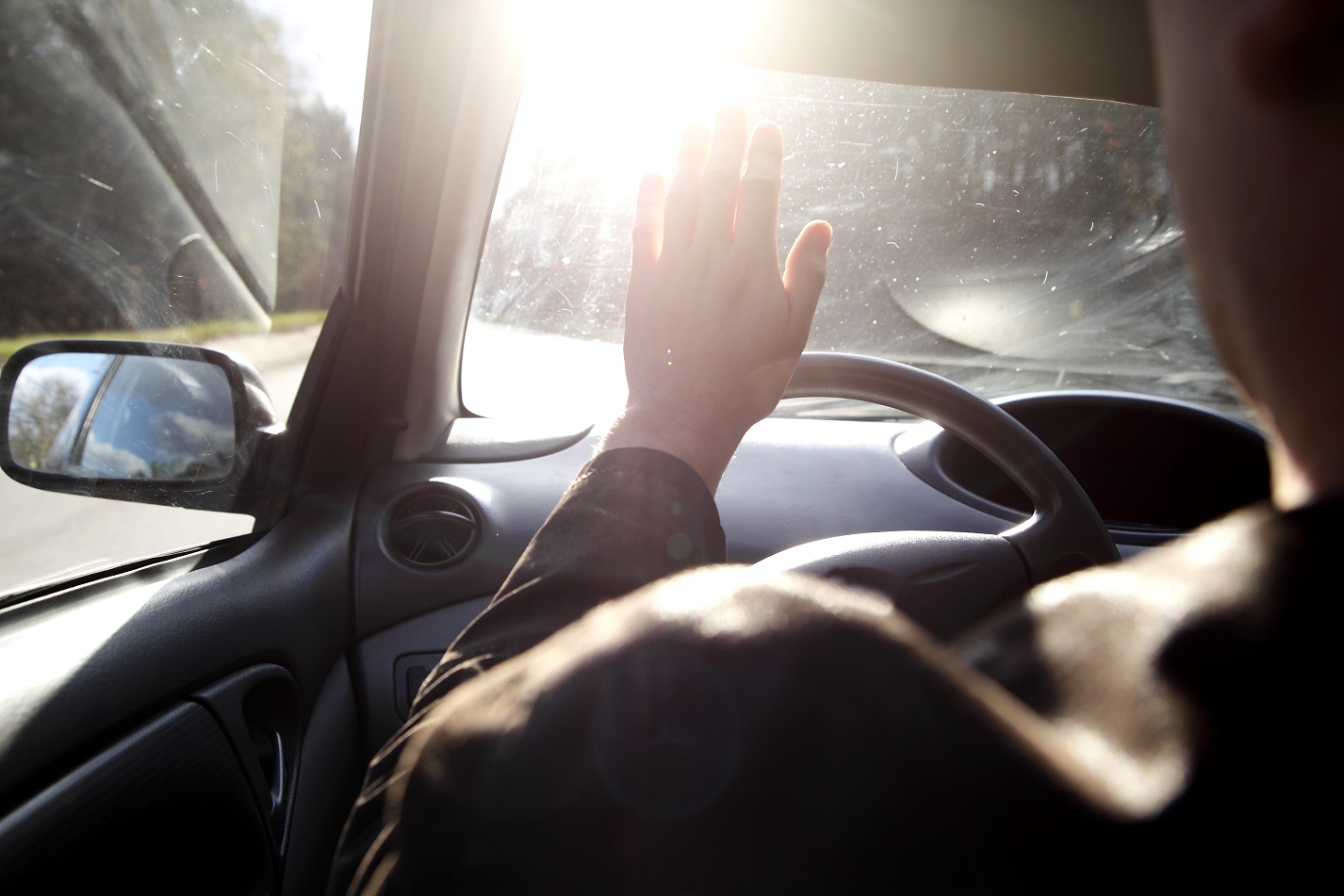 Man blinded by the sun with a scratched glass
