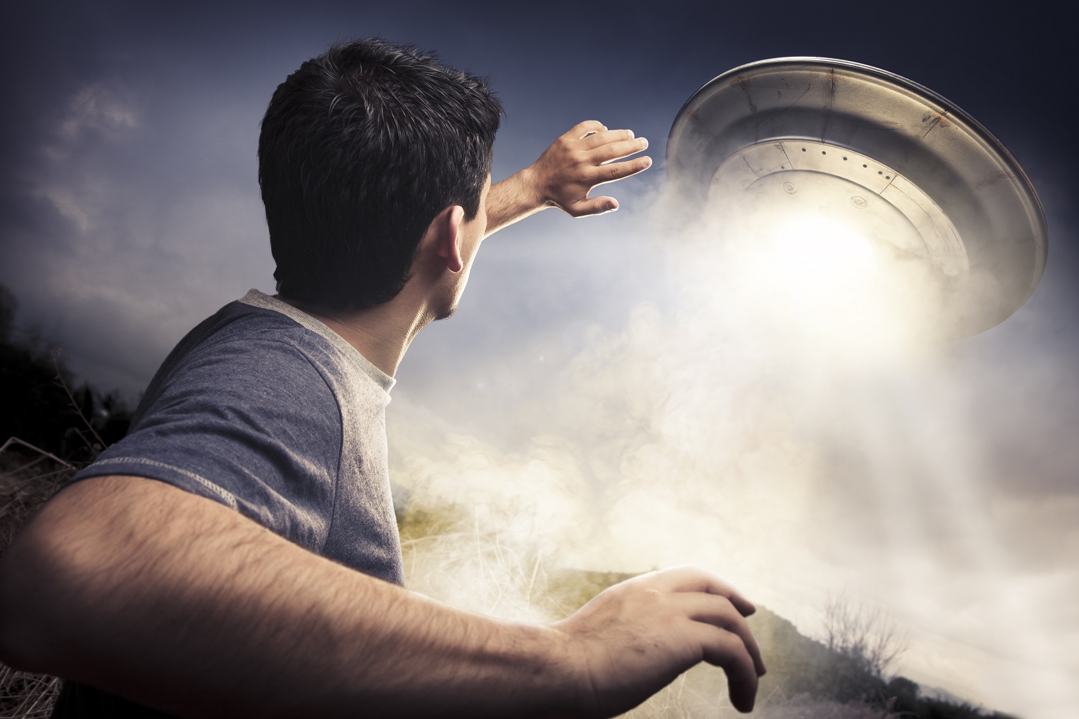 Young man is running away from a UFO.