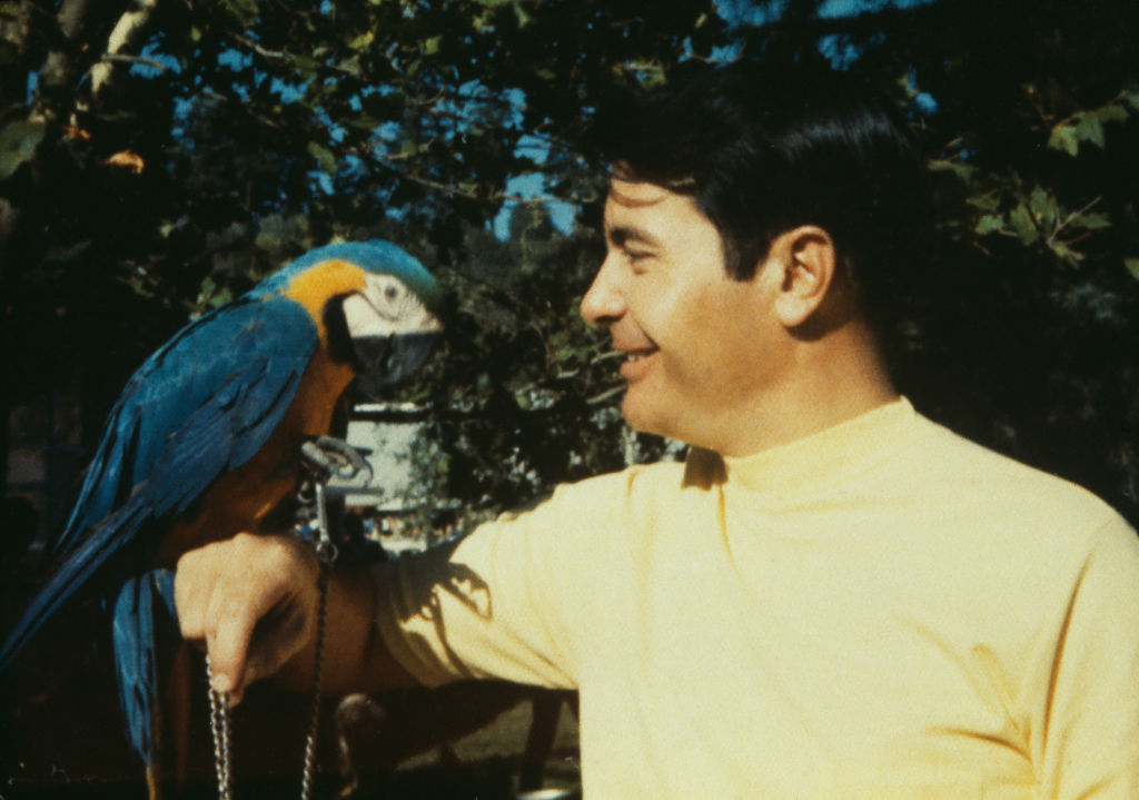 Jim Jones (1931 - 1978), founder of the Peoples Temple cult, pictured with a parrot