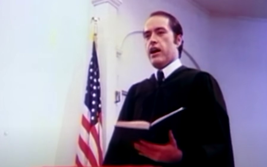 Powers Boothe as Rev. Jim Jones