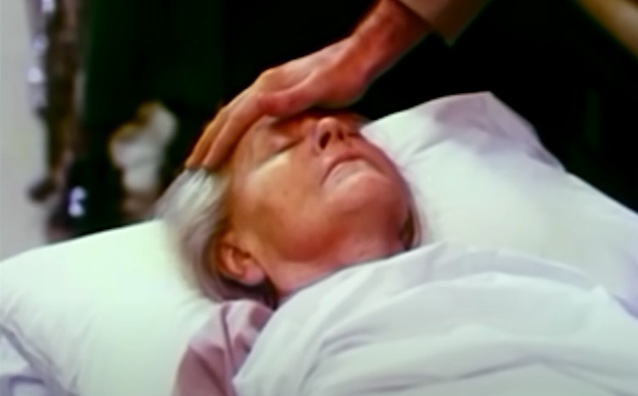 Powers Boothe as Jim Jones healing with touch