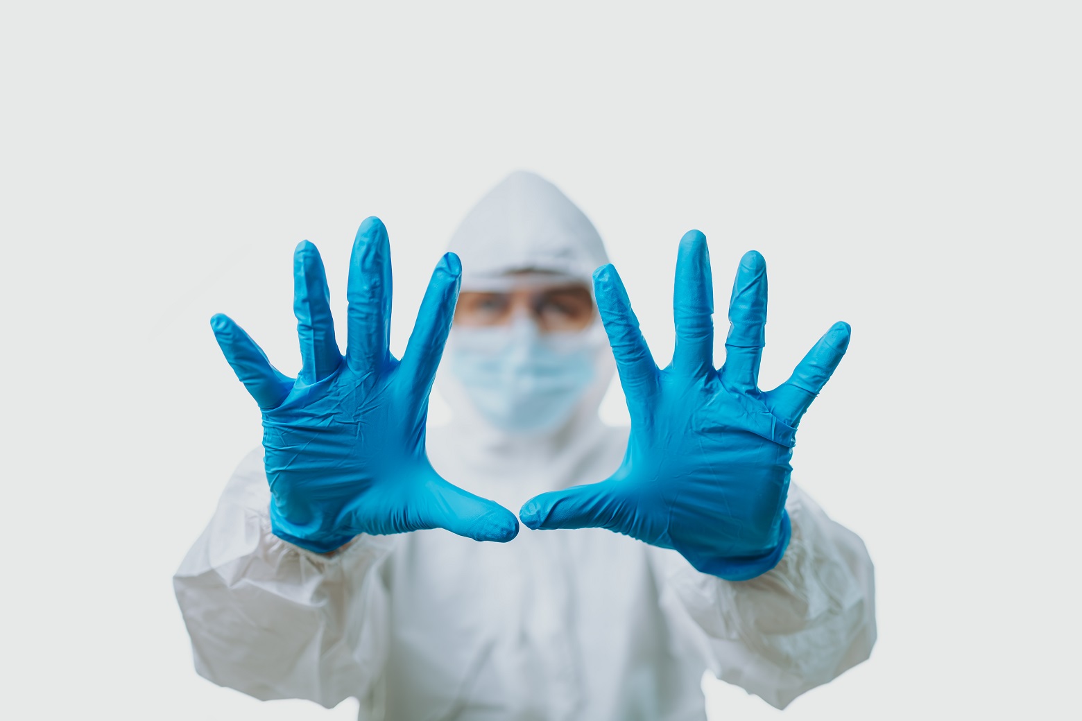 People wearing medical gloves and personal protective equipment.