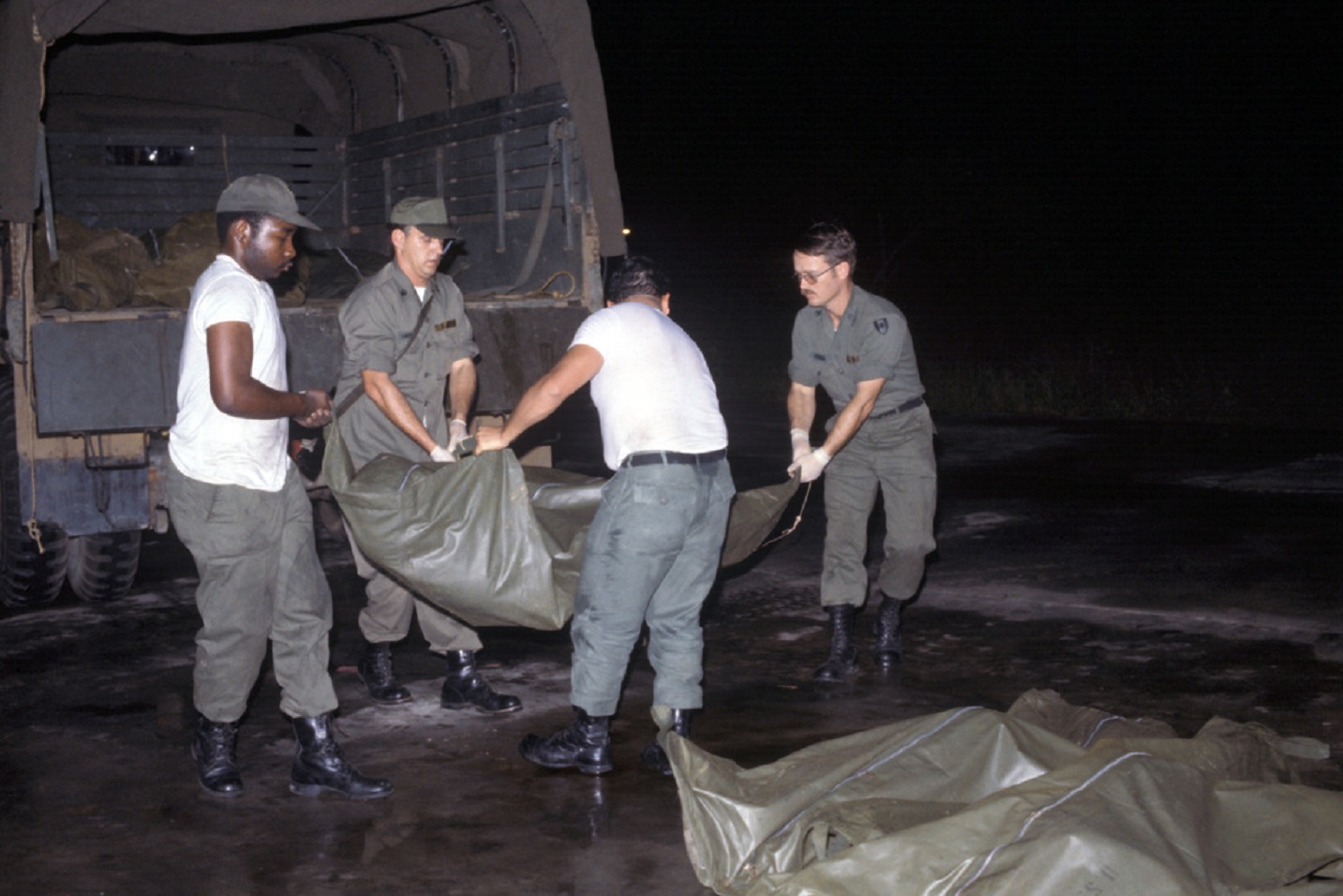 Personnel remove body bag containing the remains - 1978