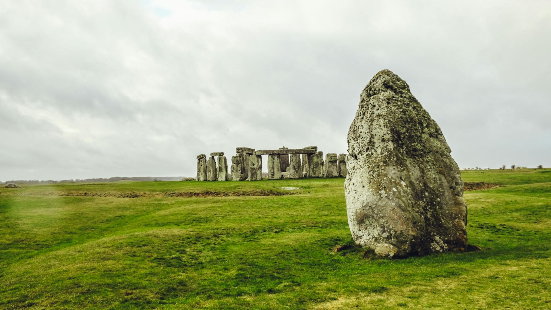 Stonehenge on the grassy field.