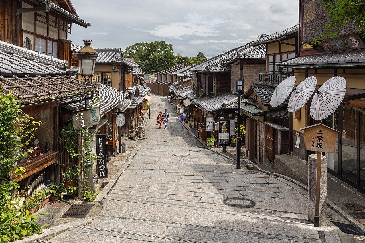 Ninenzaka, pedestrian paved street, with paper umbrellas on a storefront - Kyoto, Japan - 2019