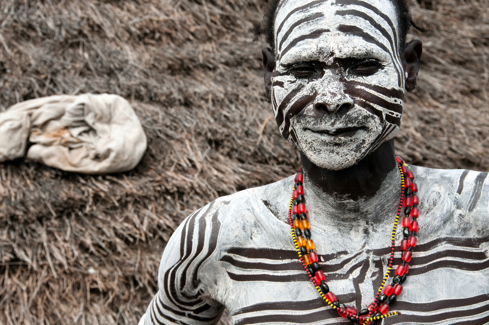Unidentified Karo Man in body and face paint