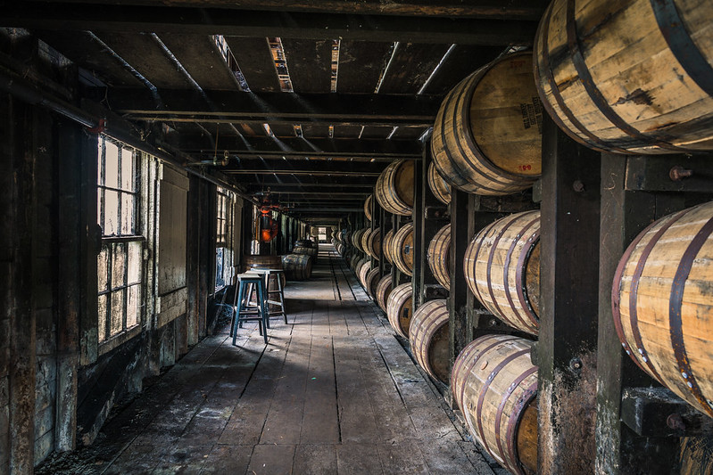 Bourbon oak barrels sit in their racks inside Warehouse