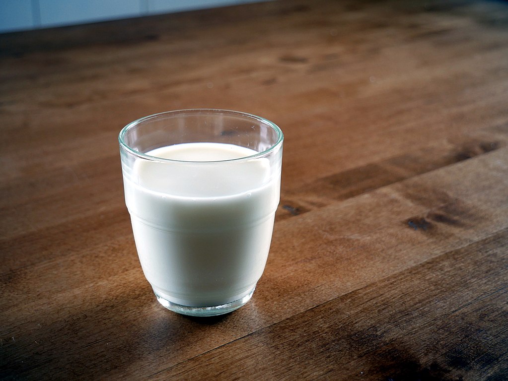 Glass of milk placed on a wooden table
