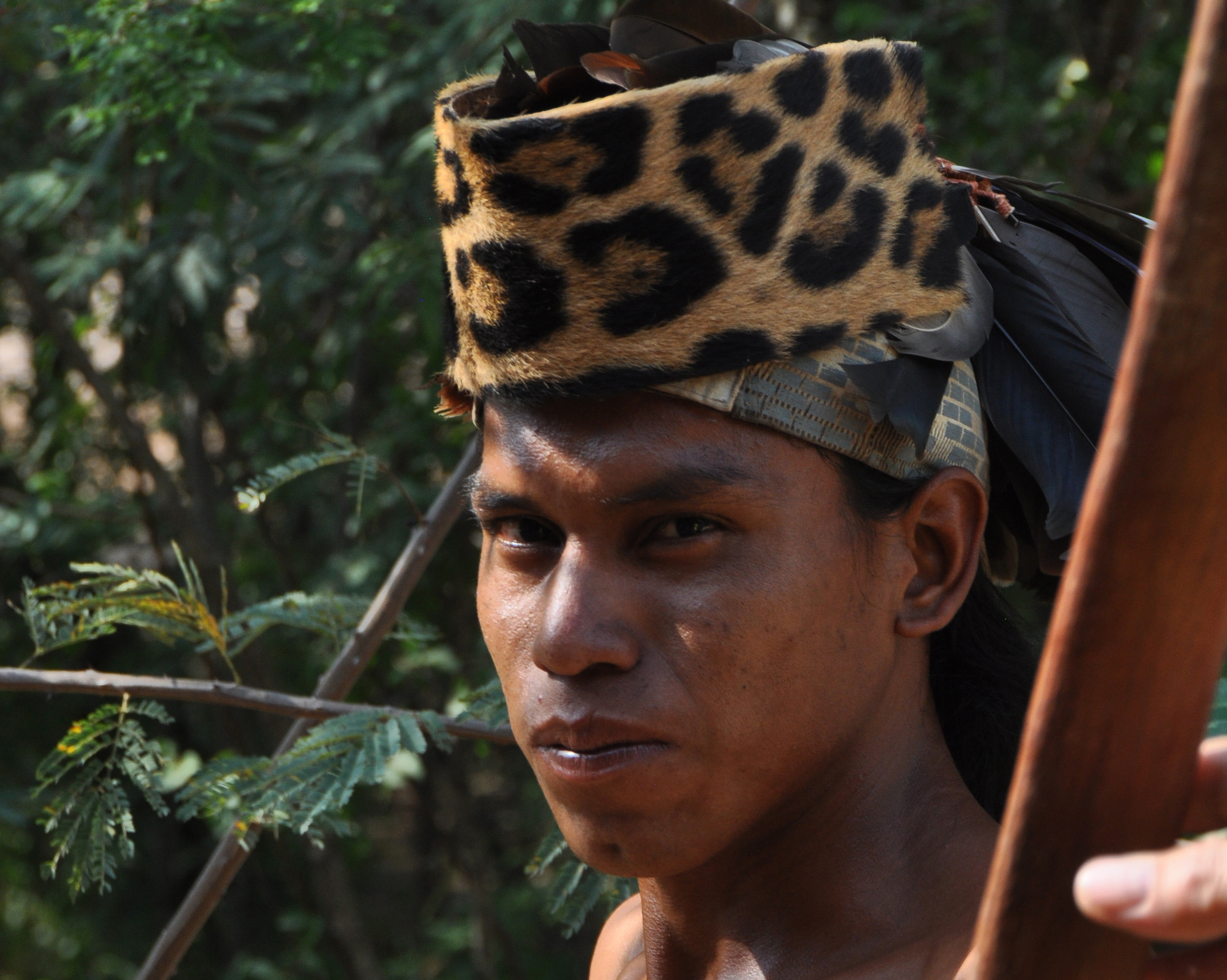An Ayoreo native wears a hat made from the skin of a leopard