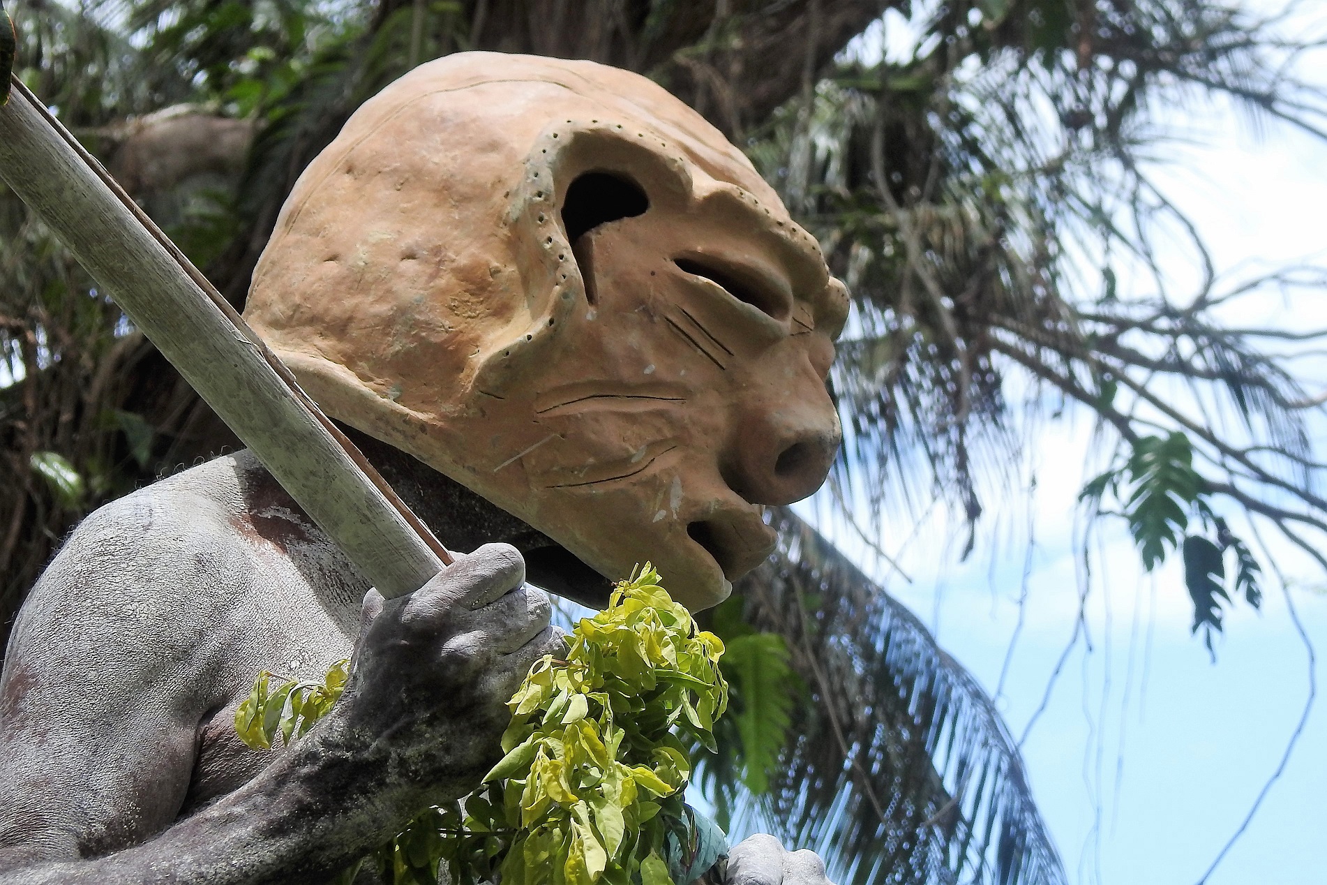 Madang, Papua New Guinea, October 28, 2017. Masked Mudman at a Sing Sing in Madang