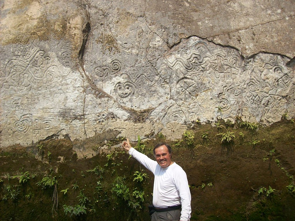 Sixto Paz Wells showing petroglyphs during a field trip to Paititi