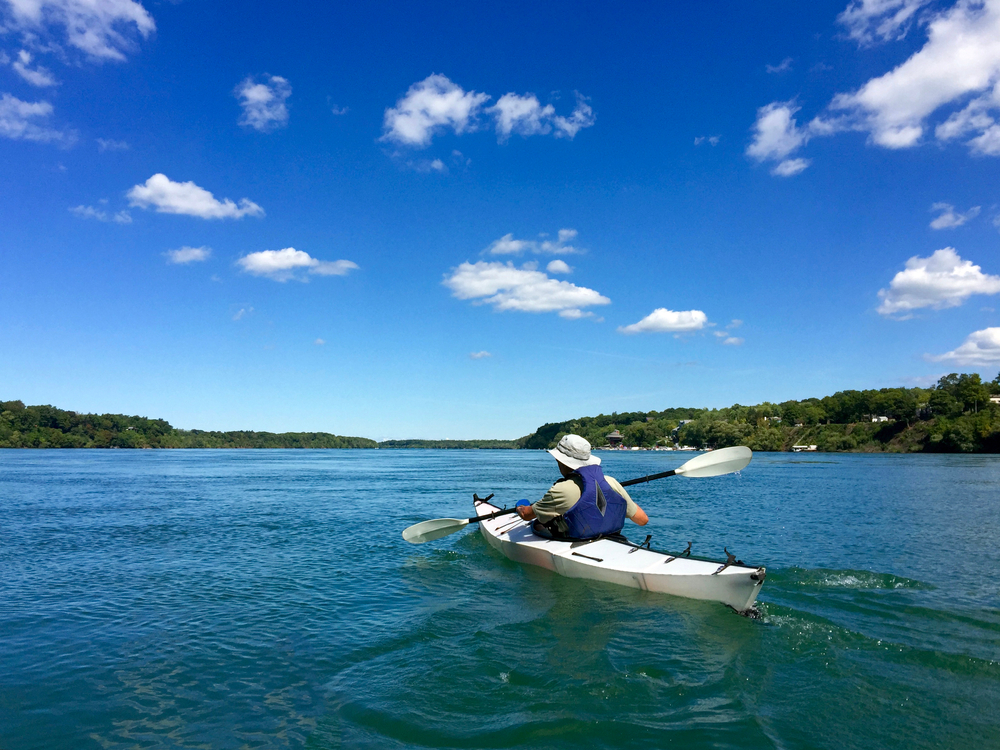 A person in a white kayak paddles the Niagara River