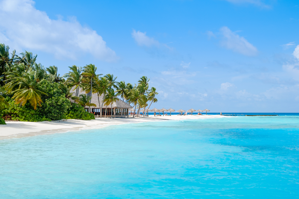 A corner of the island resort with a gradual blue sea in Maldives