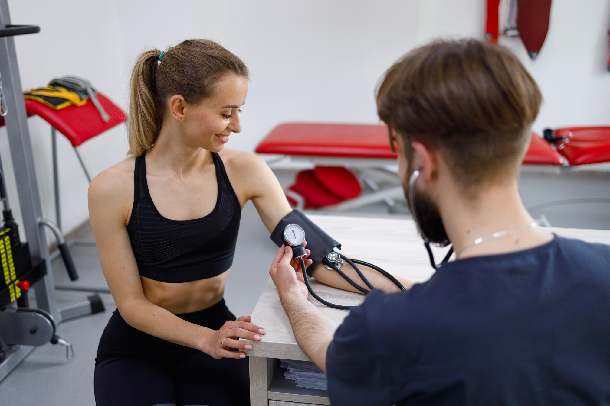 Female athlete undergoes an exercise tolerance test with a cardiologist physiotherapist.