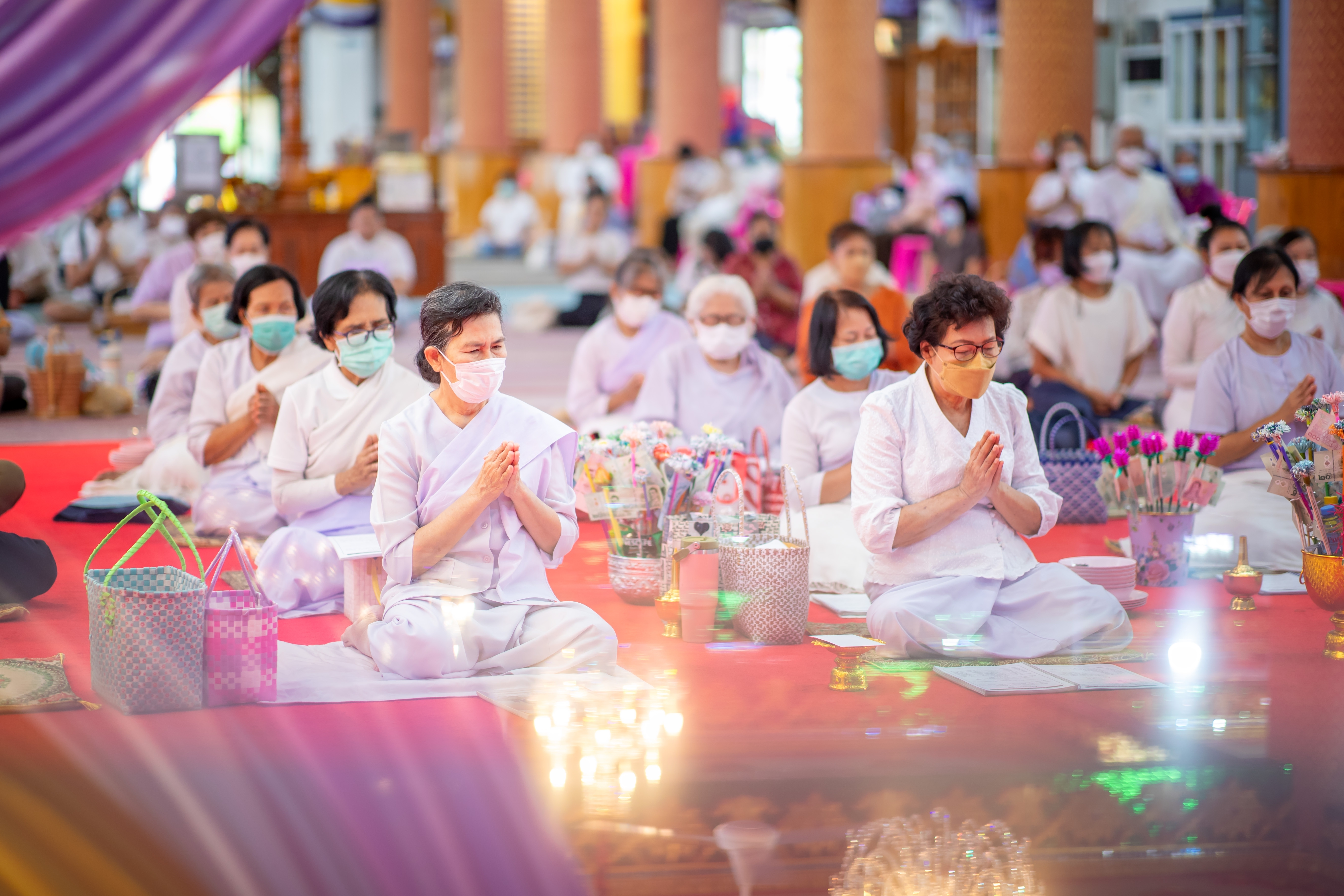 Buddhist people are sitting and listening to monks - 2023