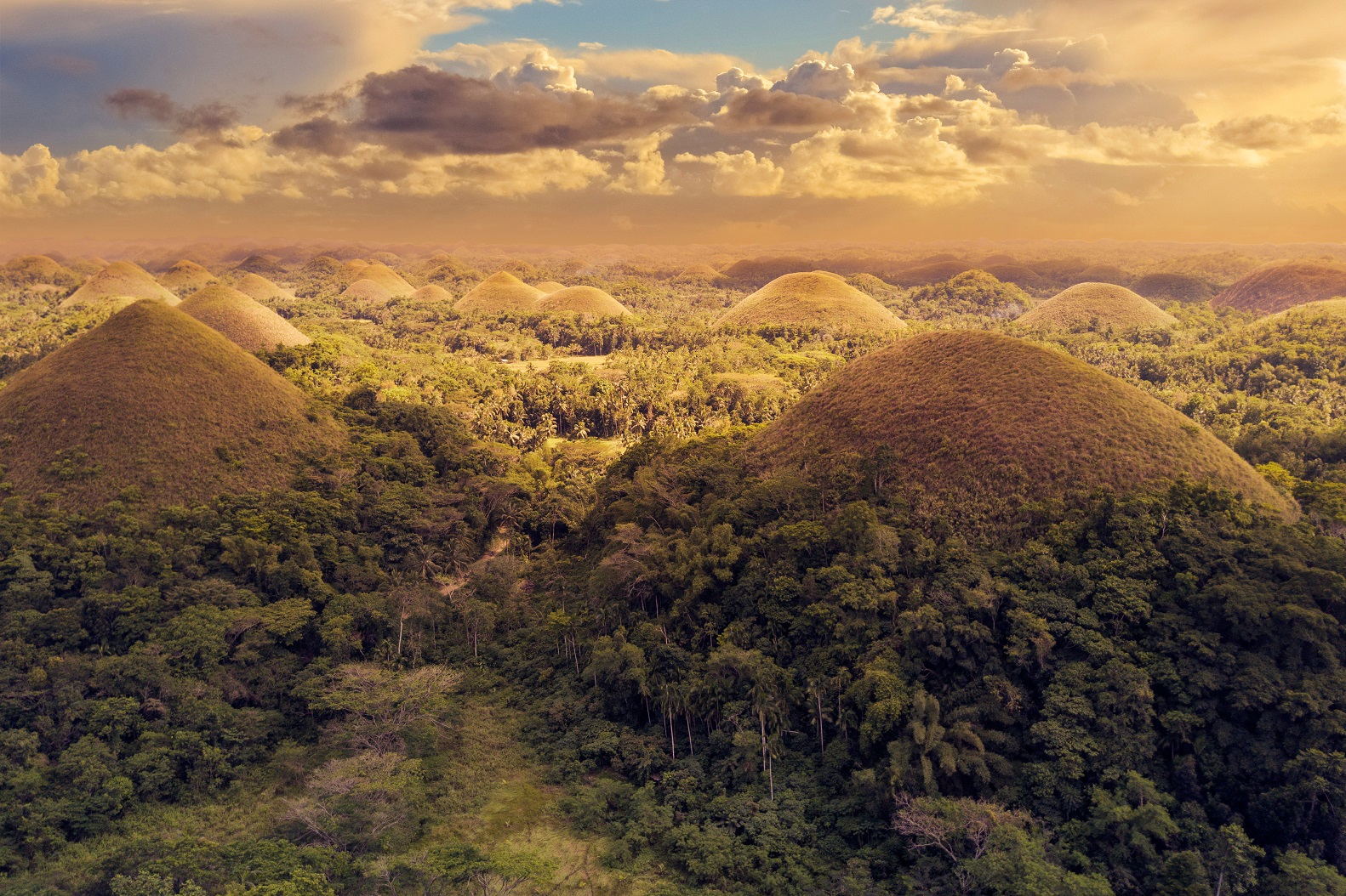 Dramatic afternoon aerial of Chocolate Hills in Bohol.