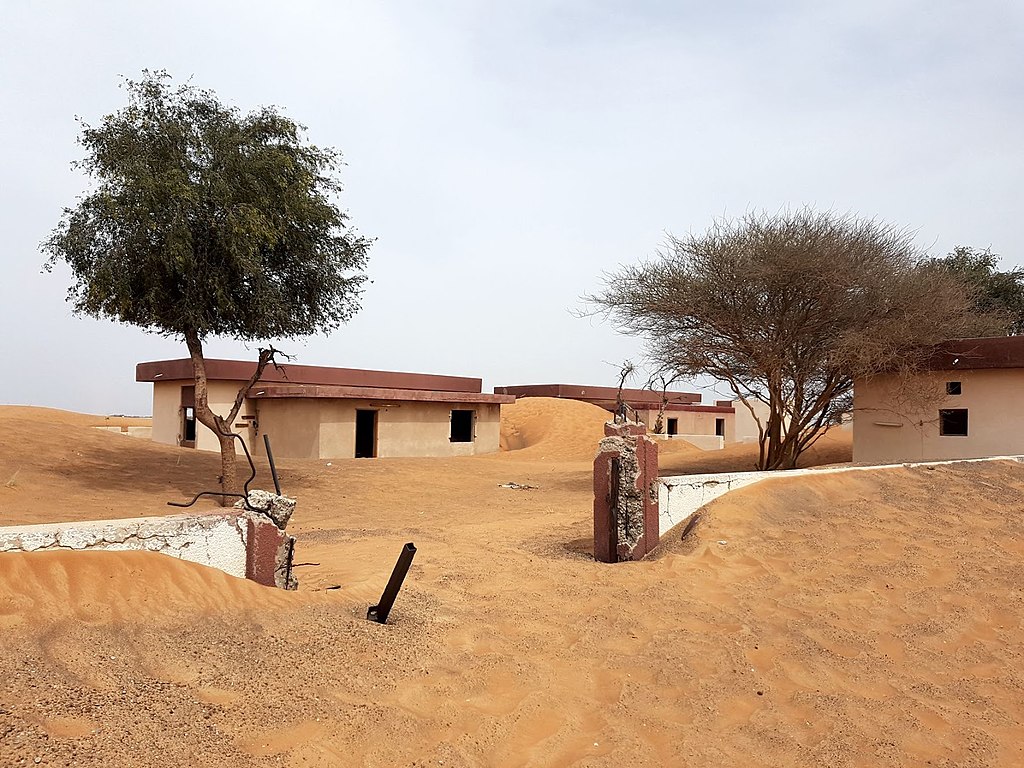 Group of abandoned houses and a mosque in the desert south of Madam town in Sharjah, UAE