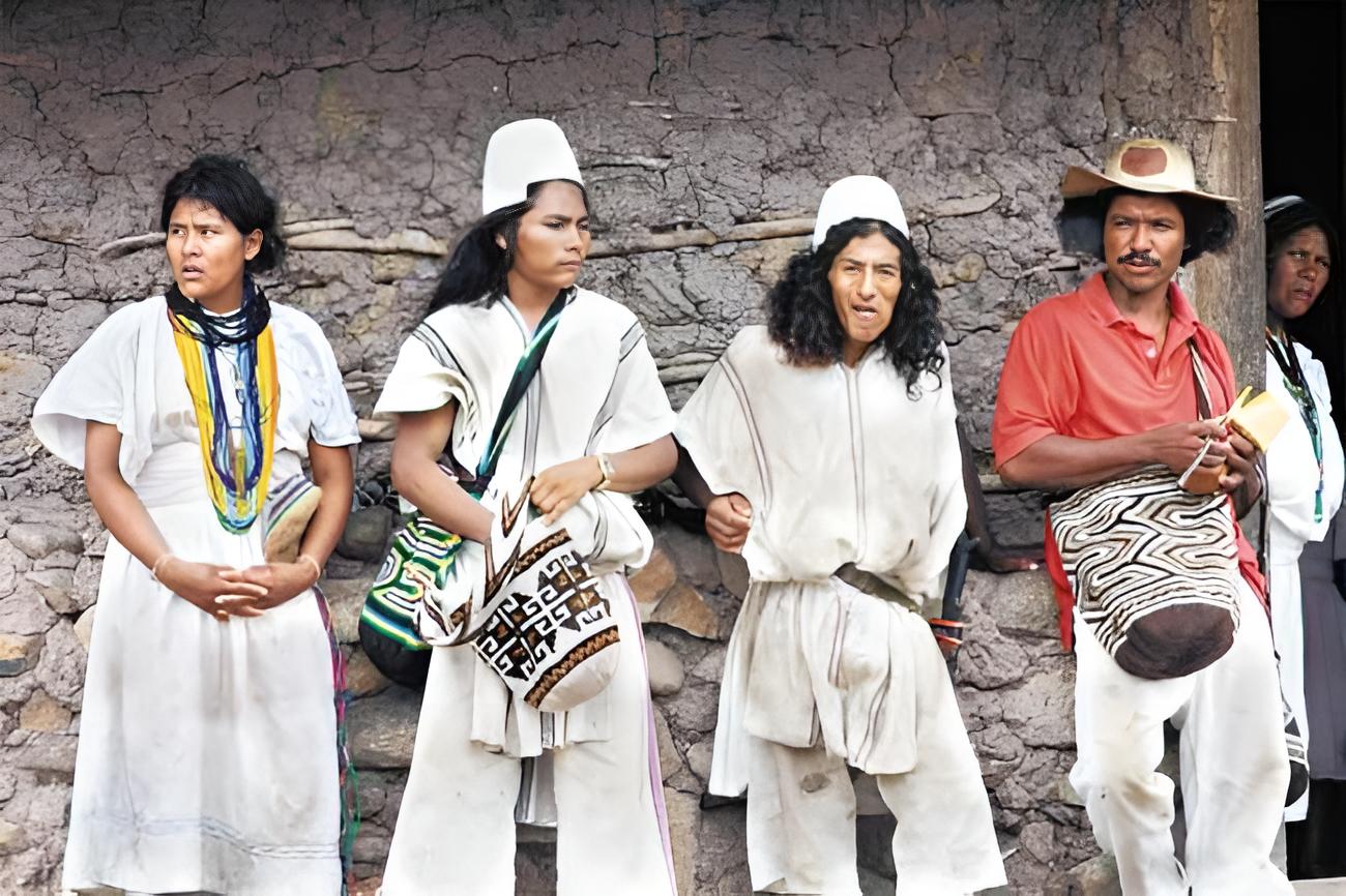 Wayuu People dressed in traditional tribe clothes leaning on wall