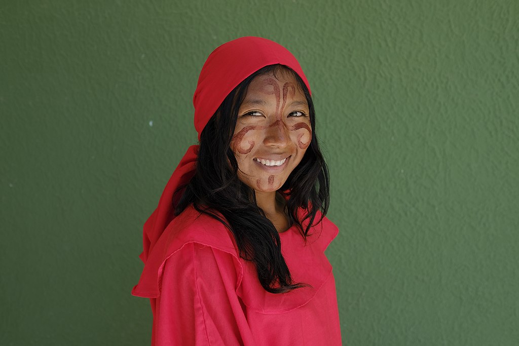 Wayuu woman wearing traditional outfit smiling and facing the camera