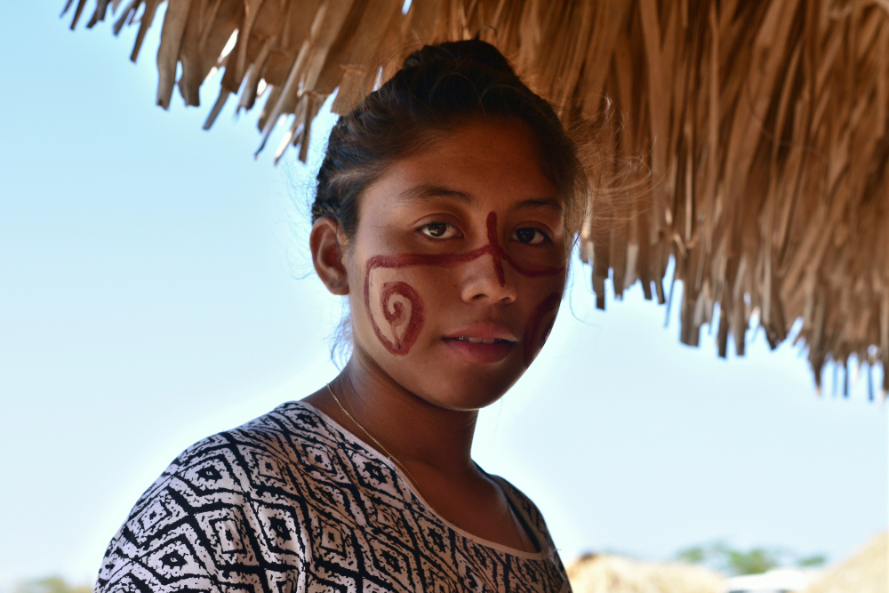 Wayuu girl with traditional paint on her face in her ranchería of the Colombian Guajira.