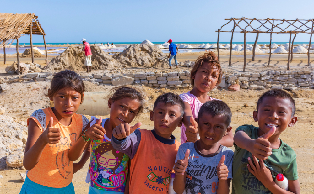 Young members comunity wayuu in salt mines of caribbean sea coastline