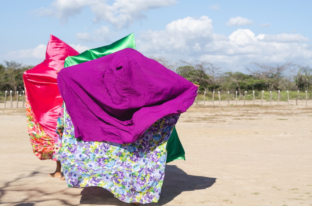 Women with colorful capes dancing typical Wayuu dance.