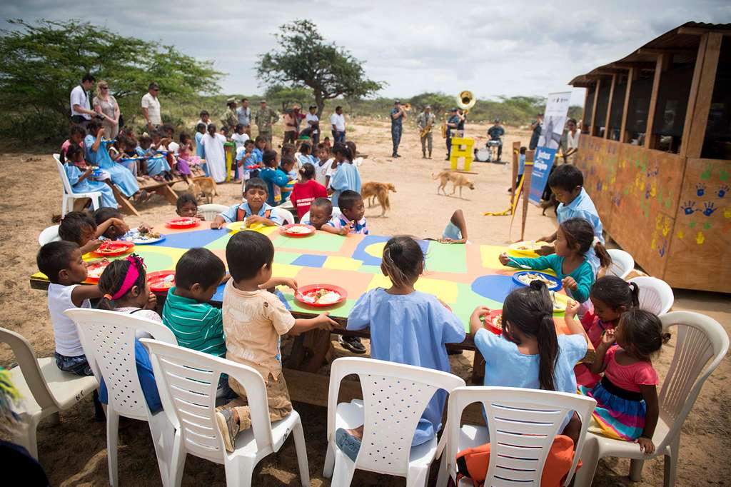 Wayuu children eat lunch at tables constructed during Continuing Promise