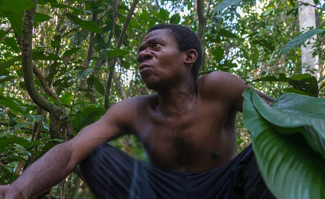 A Baka chief sitting in front of a fire