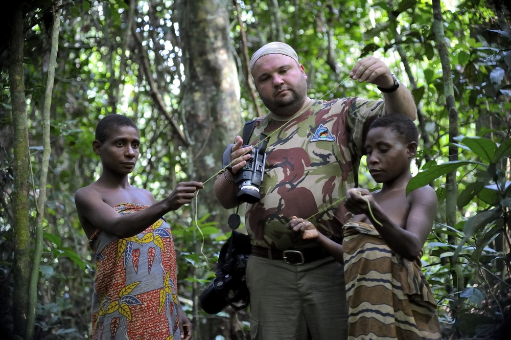 tourist and women from a tribe of pygmies of Baka