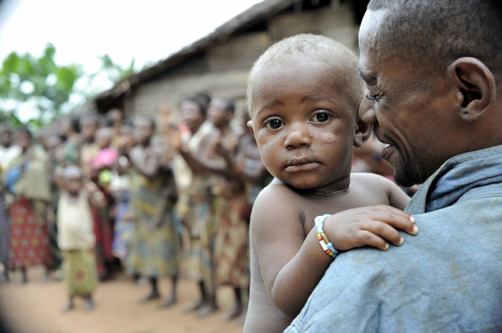 People from a tribe of Baka pygmies in village singing