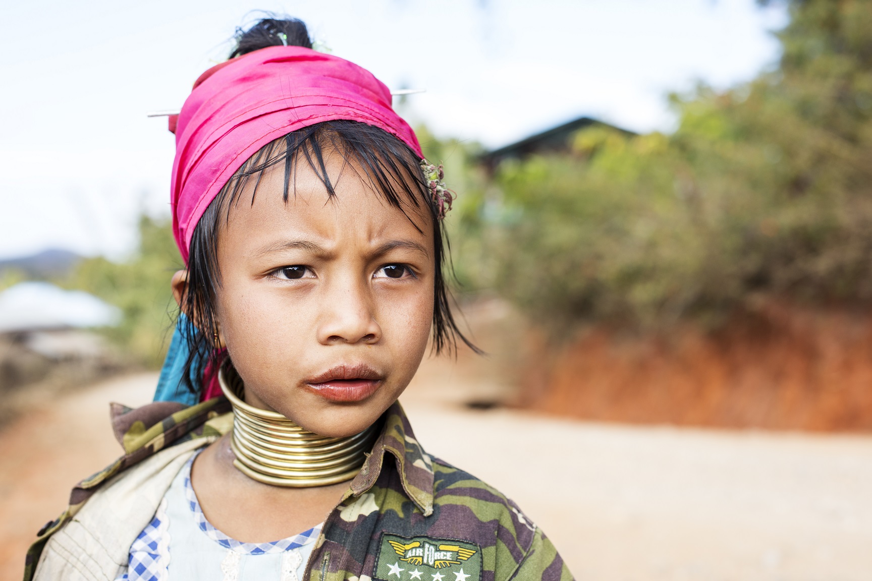 A portrait of a young girl from the Padaung tribe (Karen) who are famous for wearing large brass coils around their neck. - 2016