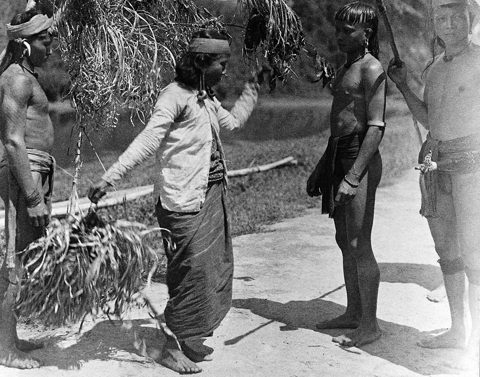 Skull trophy, Kayan woman dancing with the head of an enemy.
