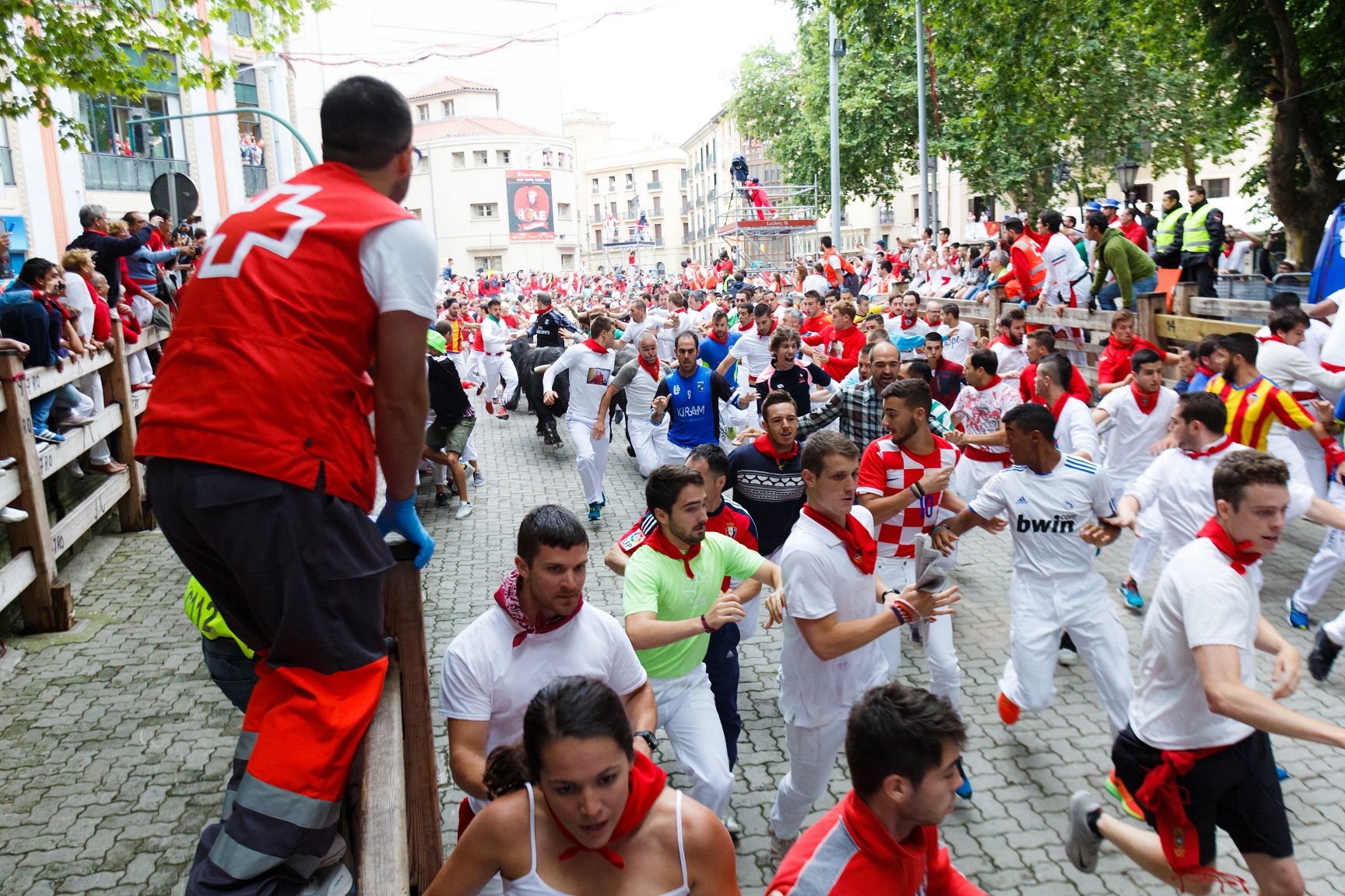 Bulls and people running on the street during the festival of San Fermin - 2017
