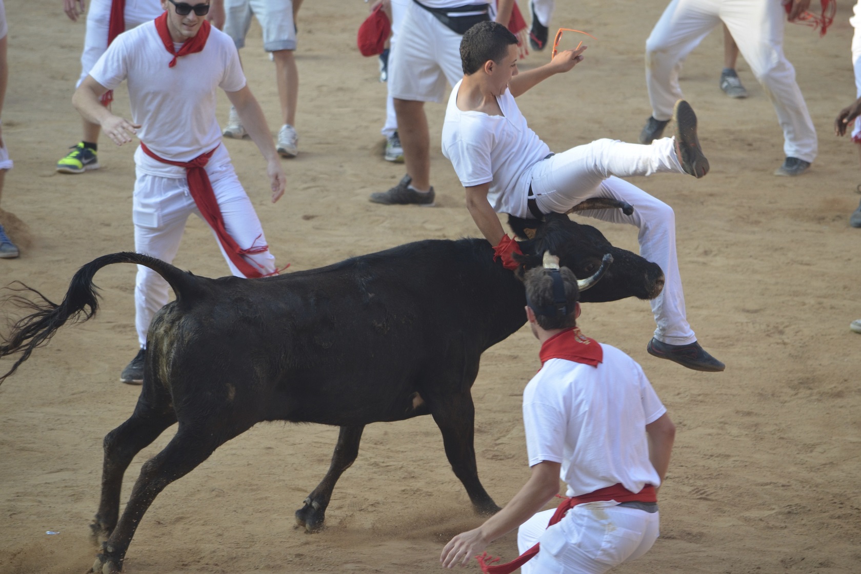 Festival goers run from bulls in the Plaza de Toros during the San Fermin fiesta - 2013