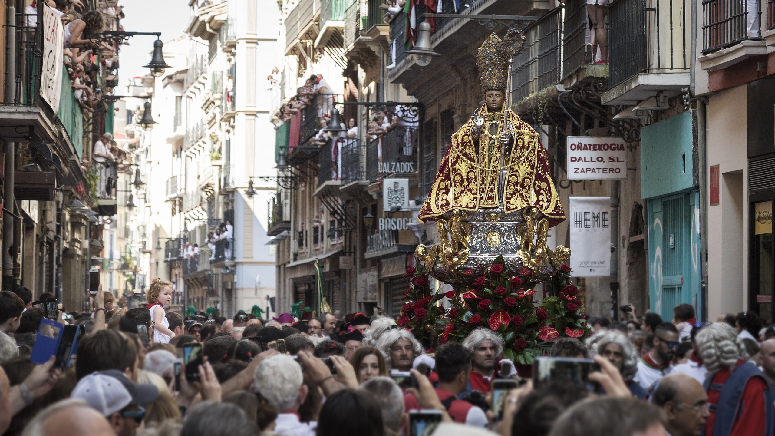 People walking on the street during the festival of San Fermin.