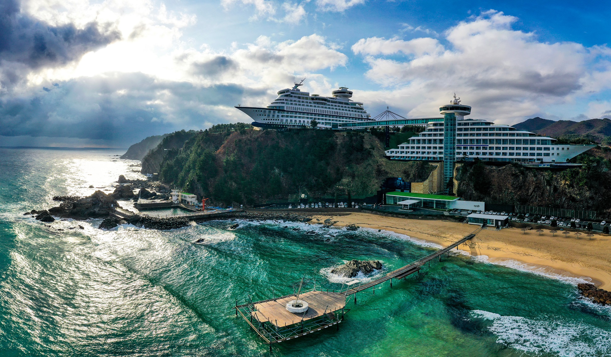 Aerial and panoramic view of sailboat-shaped cafe and Sun Cruise Resort near Jeongdongjin.