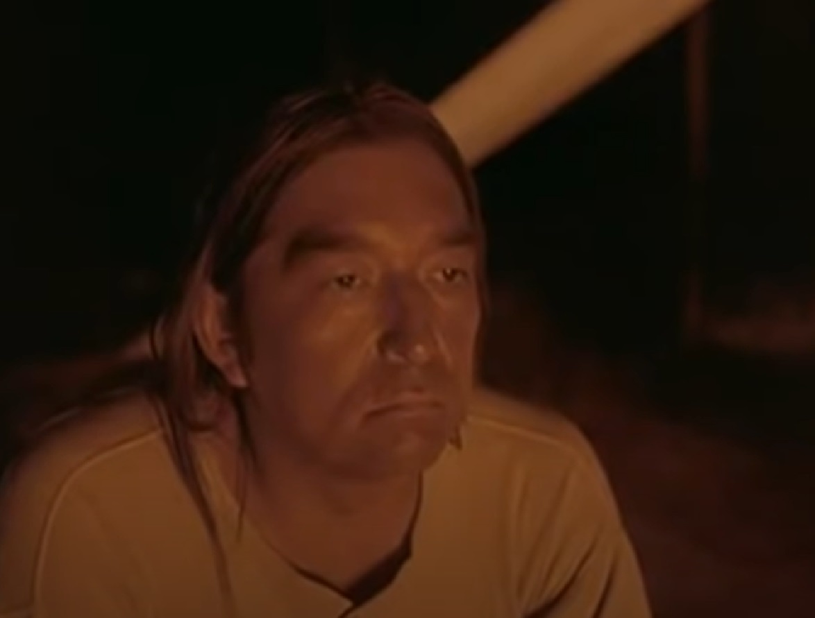 Screenshot of Ishi looking down with sad face - from The Last of His Tribe (1992)