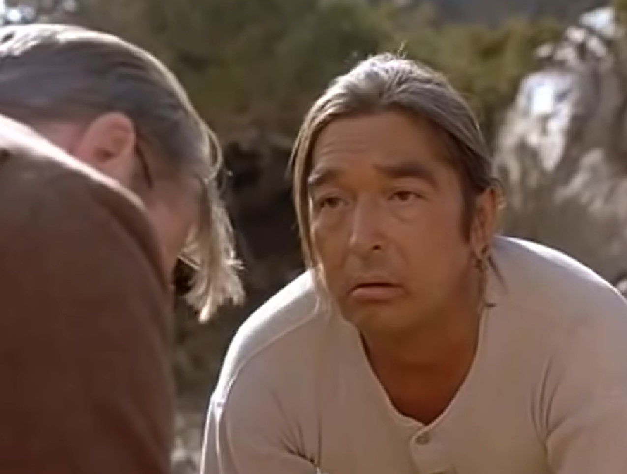 Screenshot of Ishi talking with doctor outside - from The Last of His Tribe (1992)