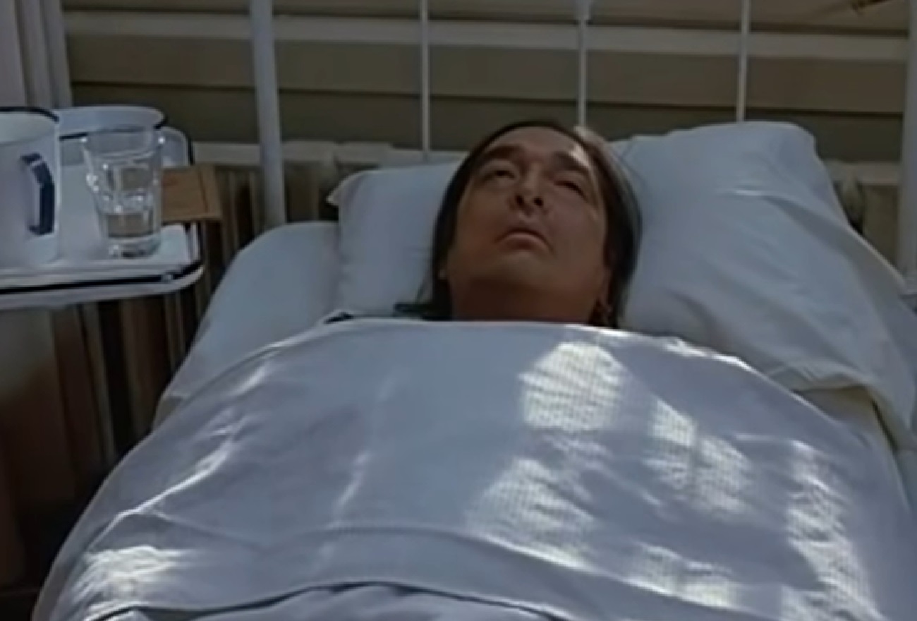 Screenshot of Ishi laying in bed sick - from The Last of His Tribe (1992)