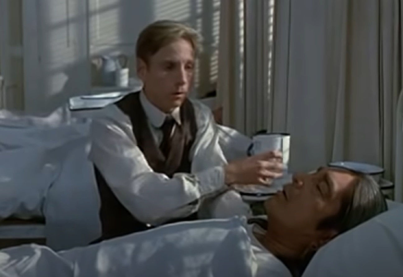 Screenshot of Ishi laying in bed sick - from The Last of His Tribe (1992)