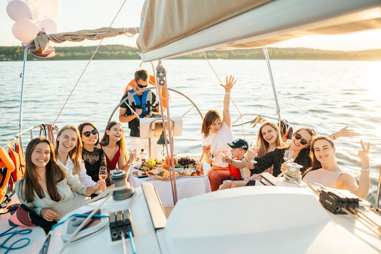 A group of people riding a yacht while having a party.