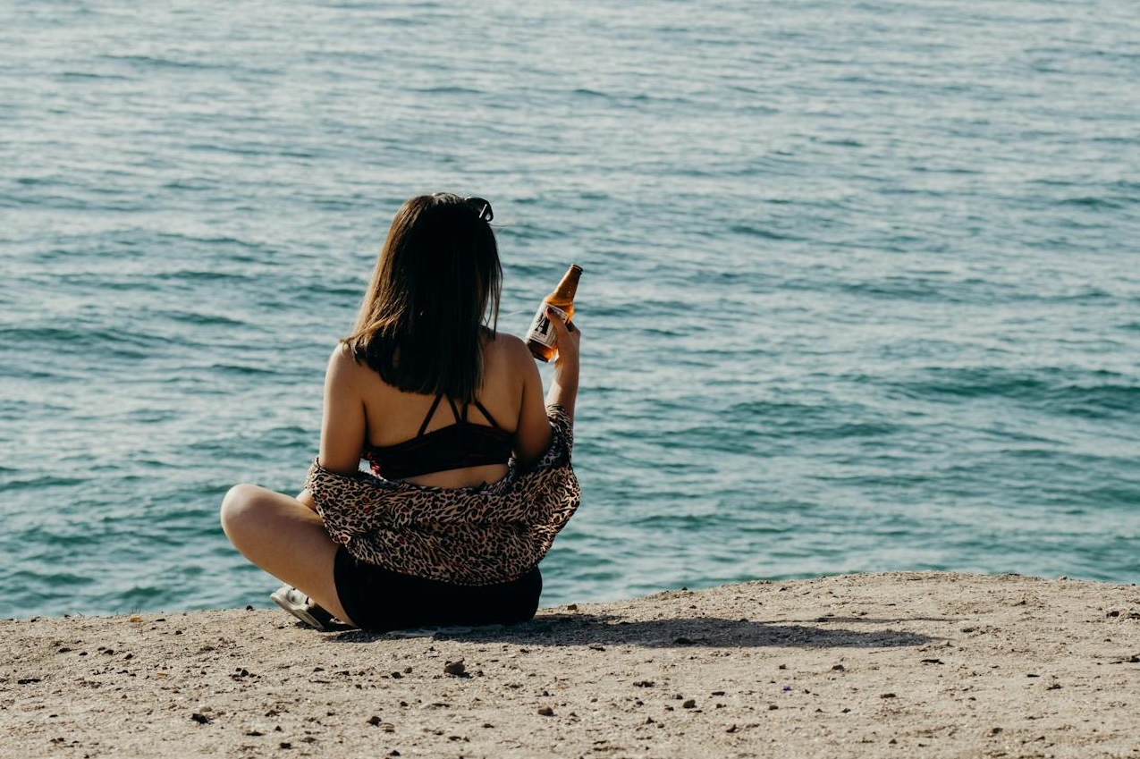 Woman seated by the Shore