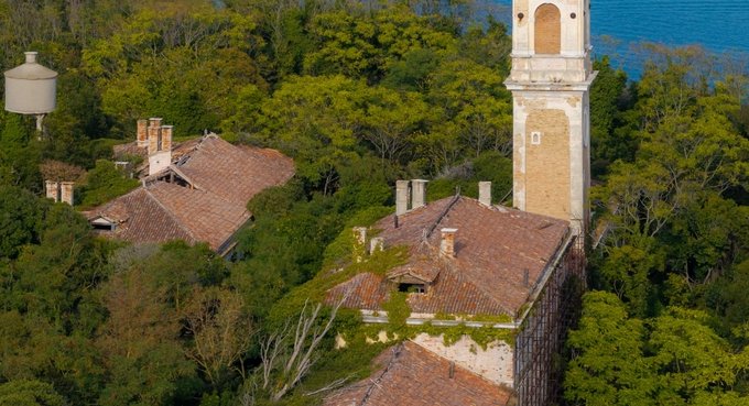 Aerial view of the plagued ghost island of Poveglia in the Venetian lagoon Venice, Italy