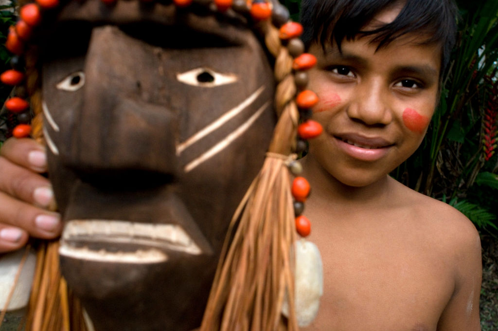 Boy form Yagua tribe holds a mask