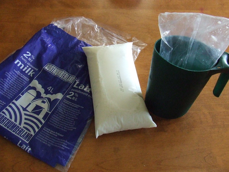 Close-up Photo of a Bagged milk placed on a wooden table