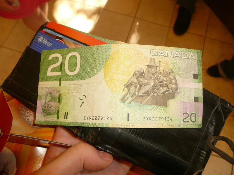 Close-up Photo of a Person holding a wallet with Canadian money