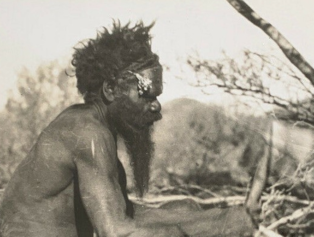 Crafting a boomerang - Central Australia - 1930s